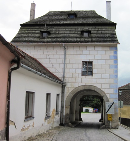 8. Exiting the town square through the only legal entry and exit point. The narrow road runs directly under a home...