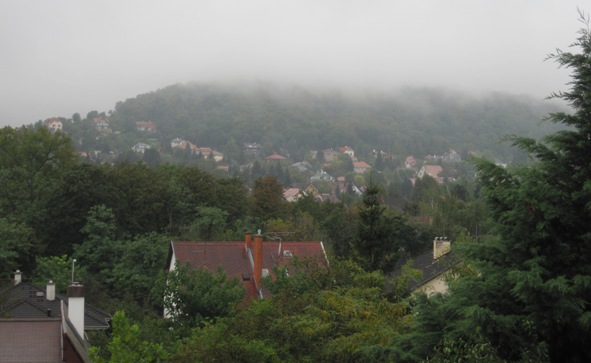 The clouds were down and rain was falling steadily over Budapest...