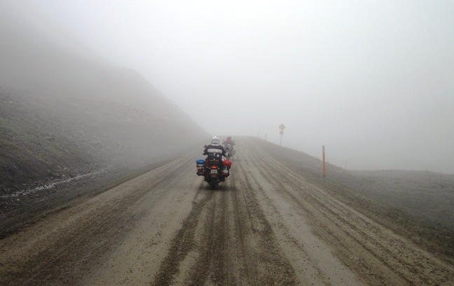 5. Trevor and Mark pick their way over slippery ground and into the mist at the top of Atigun Pass... I began to have visions of "slip slidding away", when we began the descent...