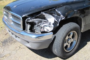 The left fender of the Dodge pick-up had been peeled off..